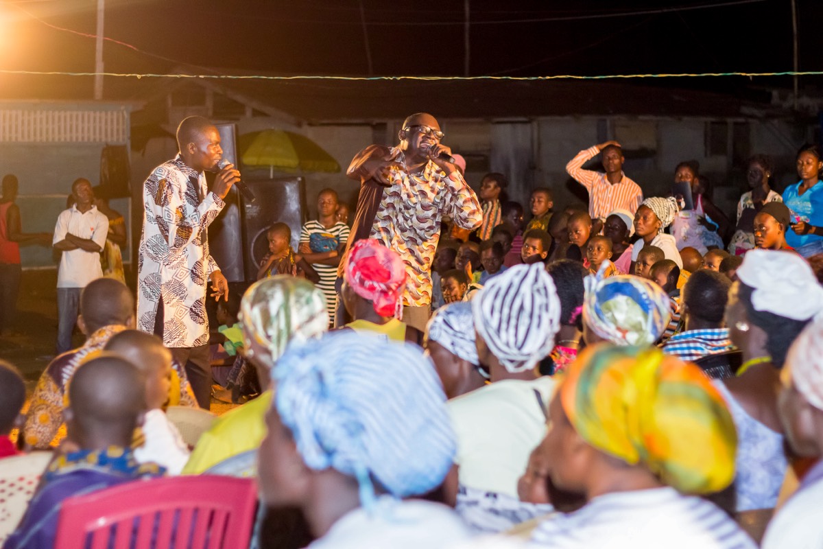 STG speakers leading an evening outreach gathering with a large crowd
